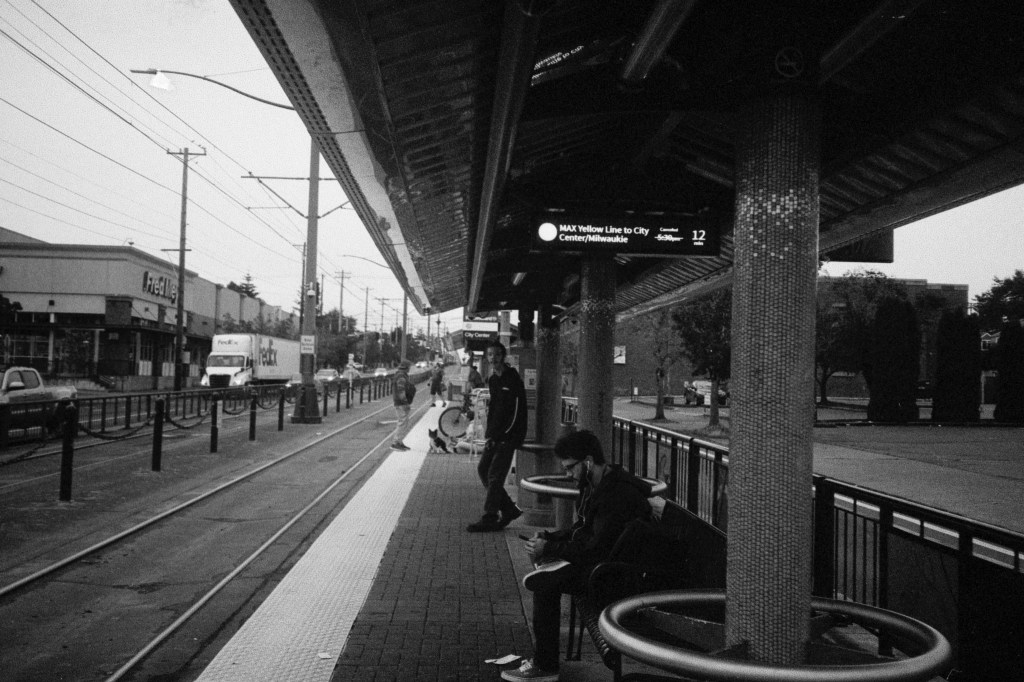 Black-and-white photo of people waiting for the MAX in Portland, Oregon.