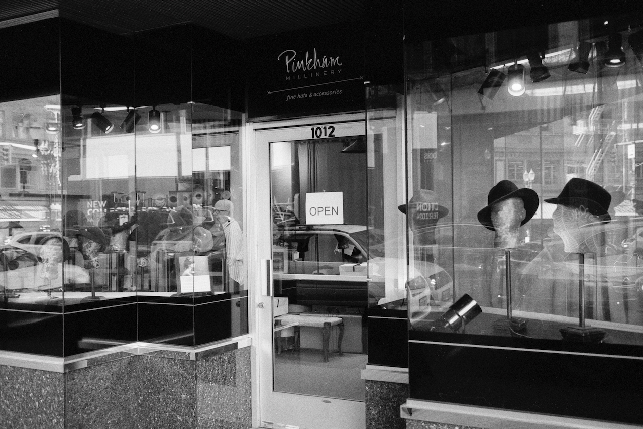Black-and-white photo of the exterior of a hat shop in Portland, Oregon.